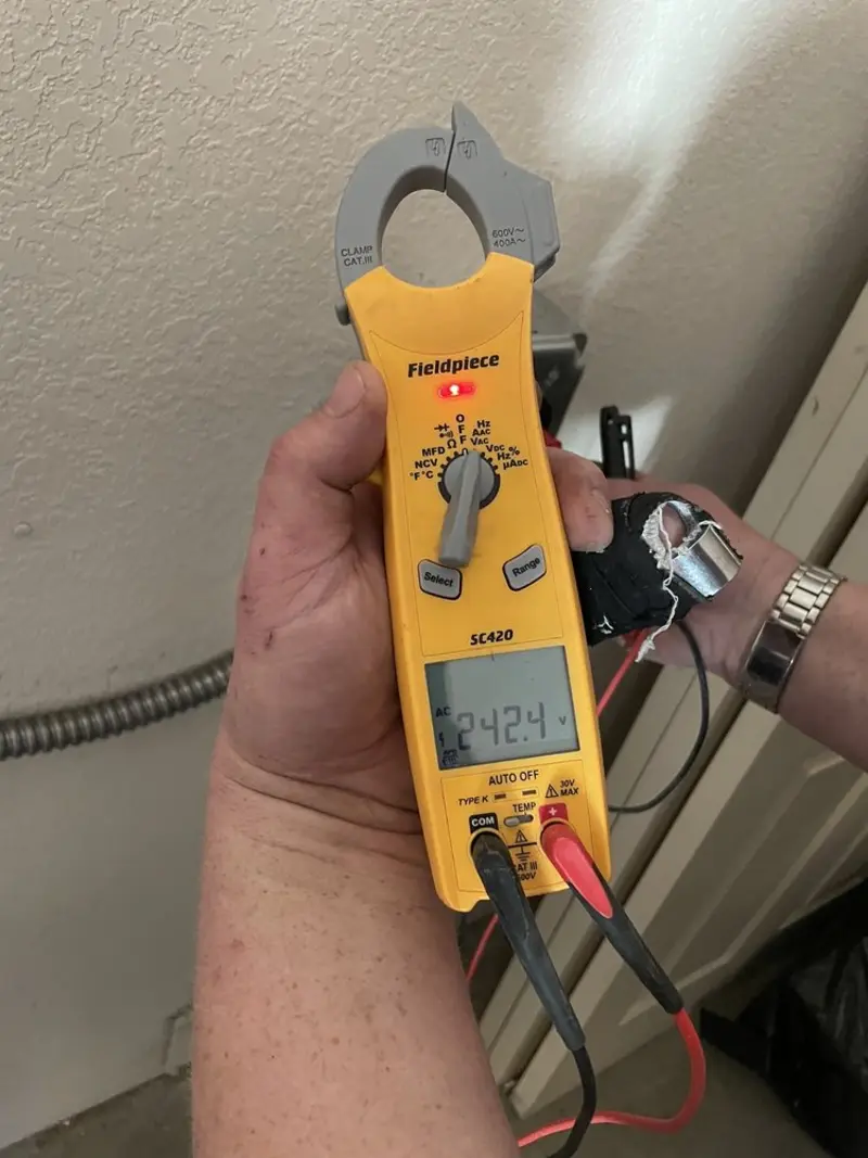 Voltage testing with clamp meter during Ceiling Fan Installation in Wells